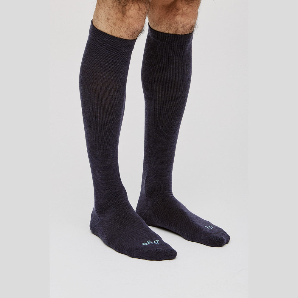 Paire navy compression socks worn on model - ideal for long-haul flights